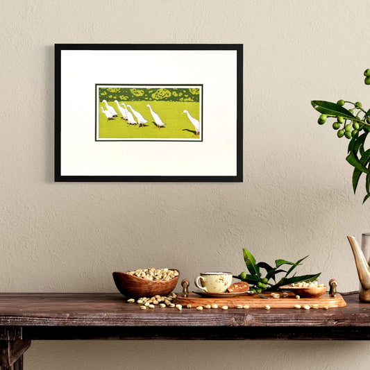 Fine art print of Indian Runner Ducks. Mounted in white, 10" x 14". In room set in black frame
