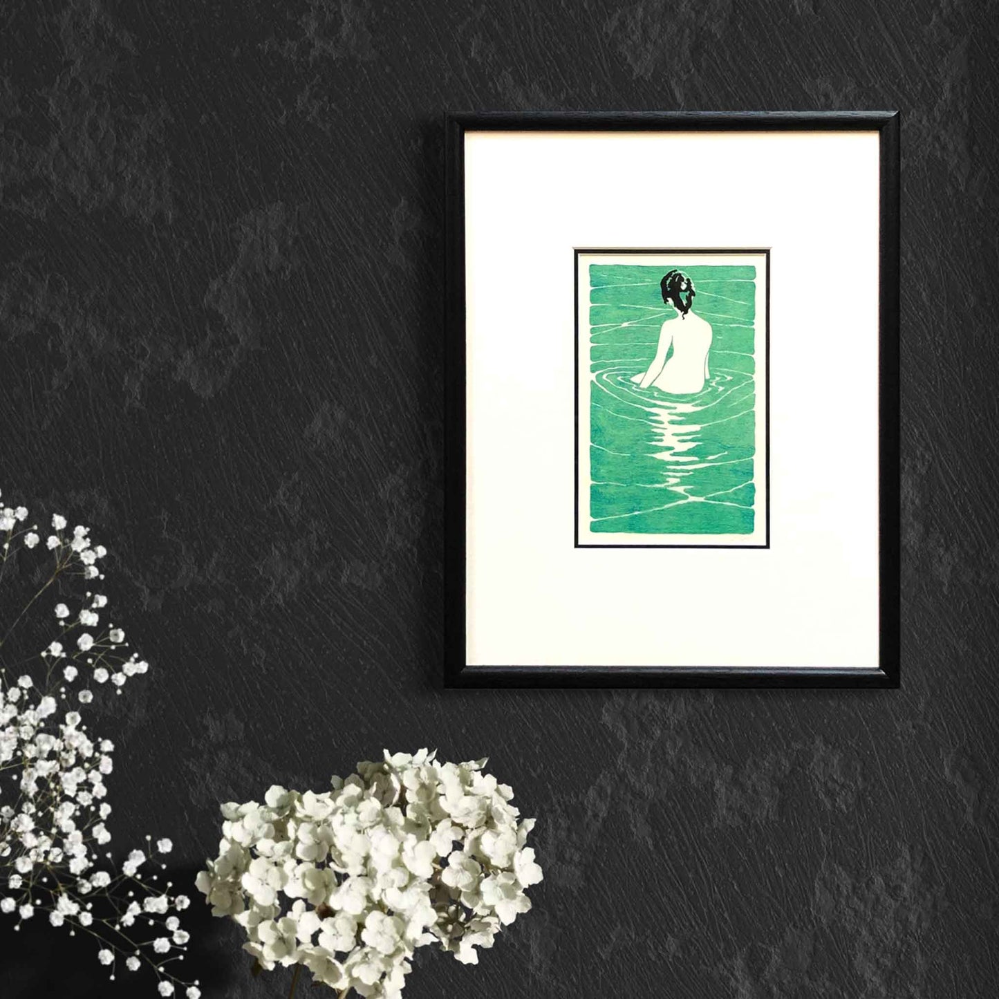 At the Hot Spring, after Ichijo Narumi — framed woodblock print by artist Claire Cameron-Smith, shown on a dark wall for scale.