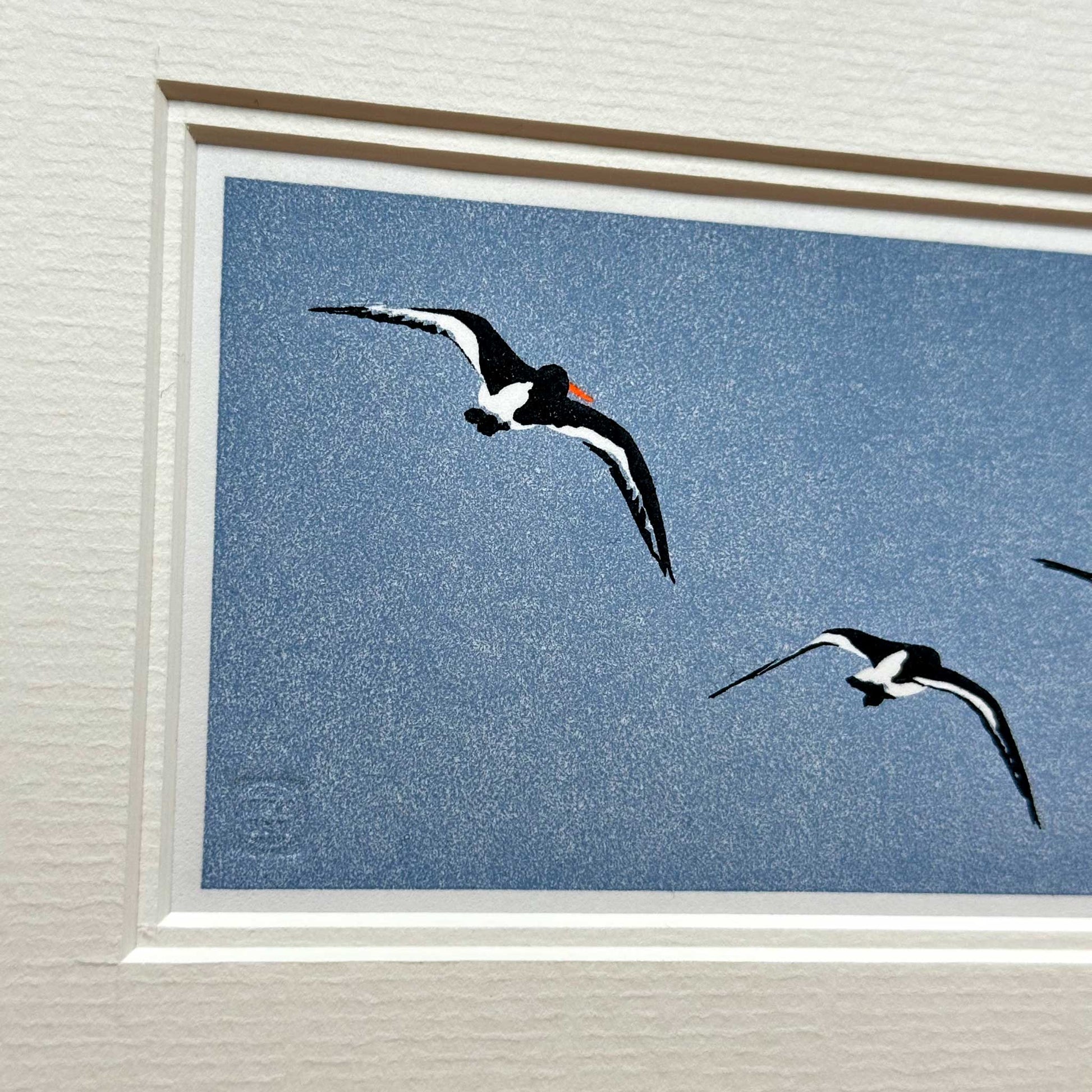 Handmade print of Oyster Catchers in Flight against blue background - detail view 1