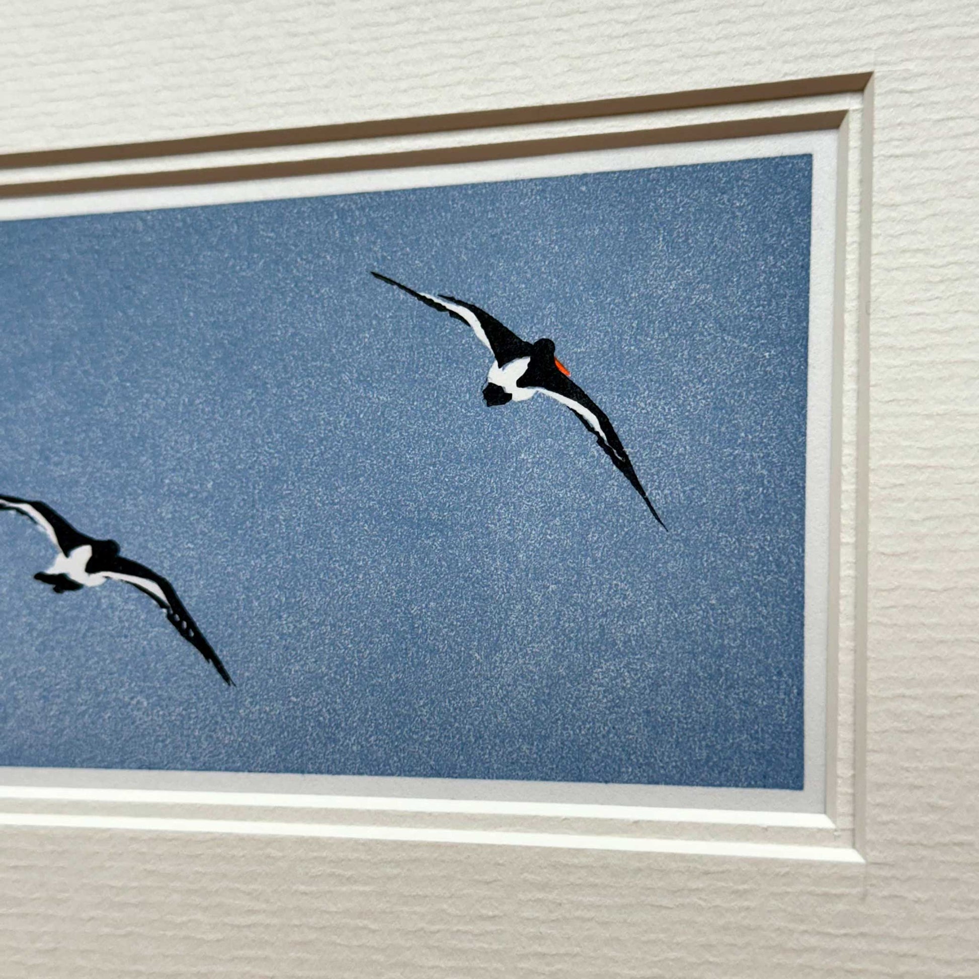 Handmade print of Oyster Catchers in Flight against blue background - detail view 3