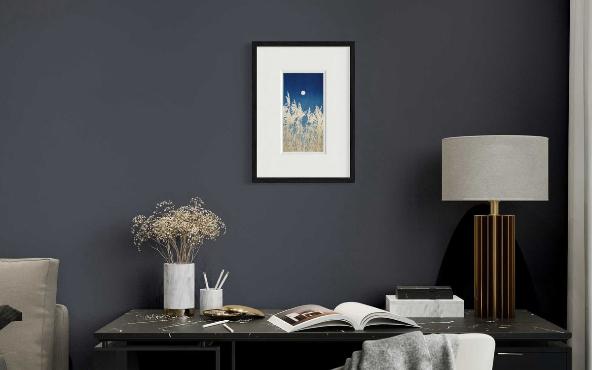 Reeds Under a Full Moon studio mounted print in black frame on dark wall