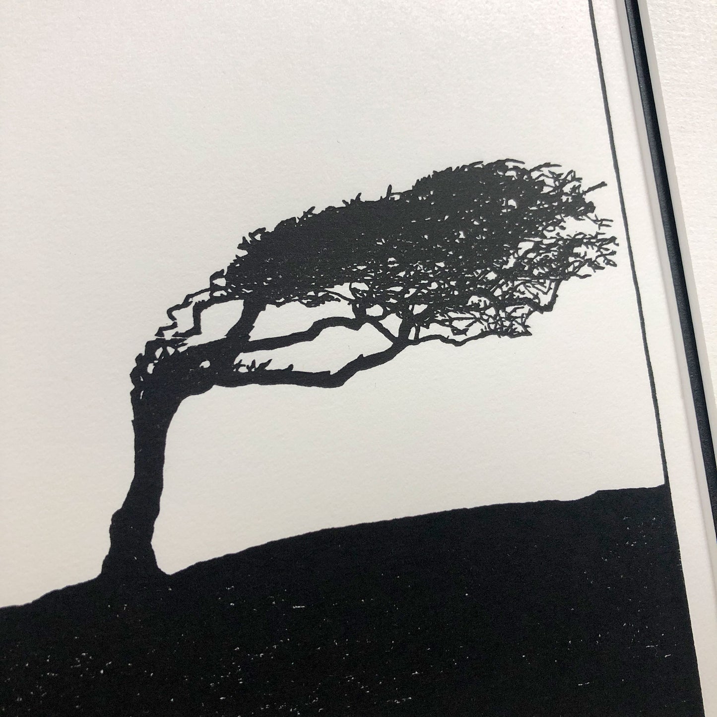 Close-up detail of hand-printed hawthorn tree showing delicate branch structure and subtle ink variation on cream paper.